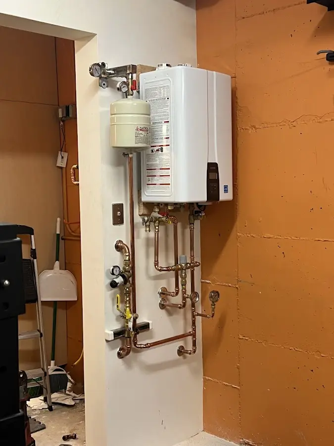 Plumbing technician inspecting water heater connections in Ocala
